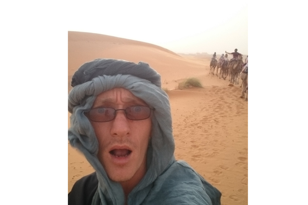 Wearing traditional Bedouin headgear in the Sahara Desert.