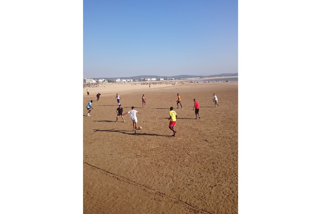 Boys enjoying a game of football on Essaouira beach. 