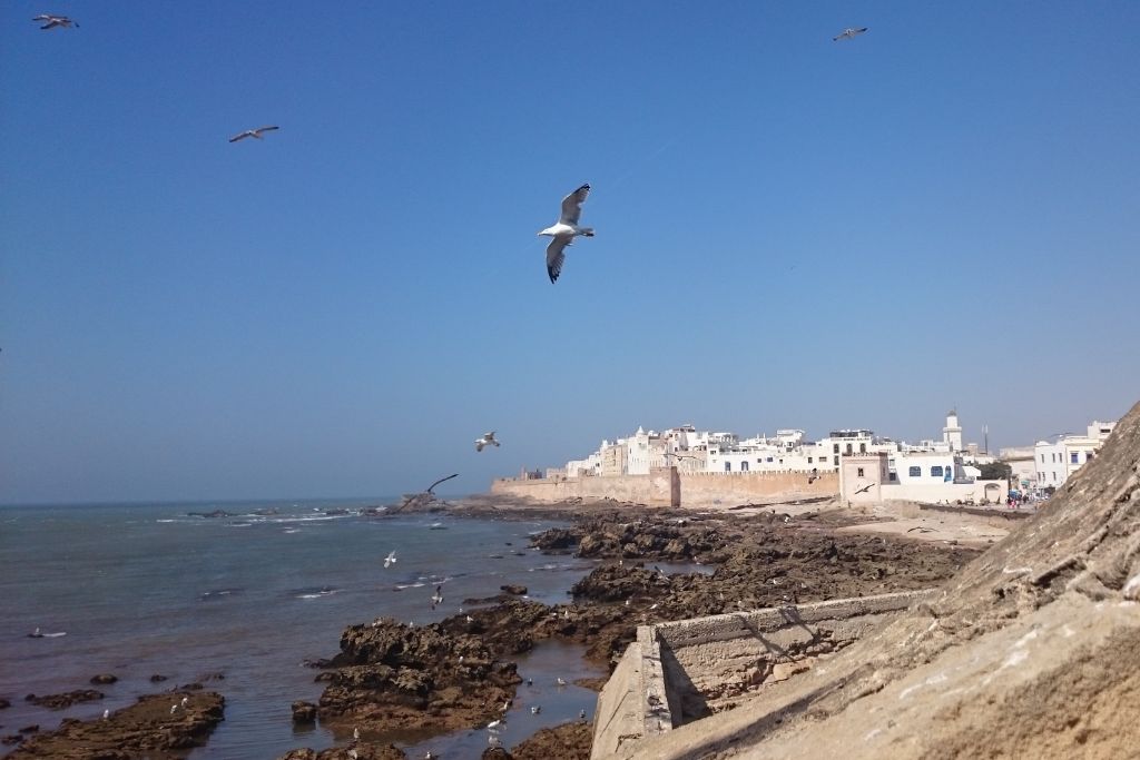 The medieval walled city of Essaouira on the edge of the Atlantic Ocean seen from a distance. 