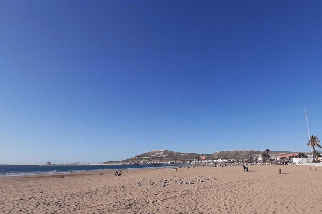Agadir's famous beach and hillside in the distance.