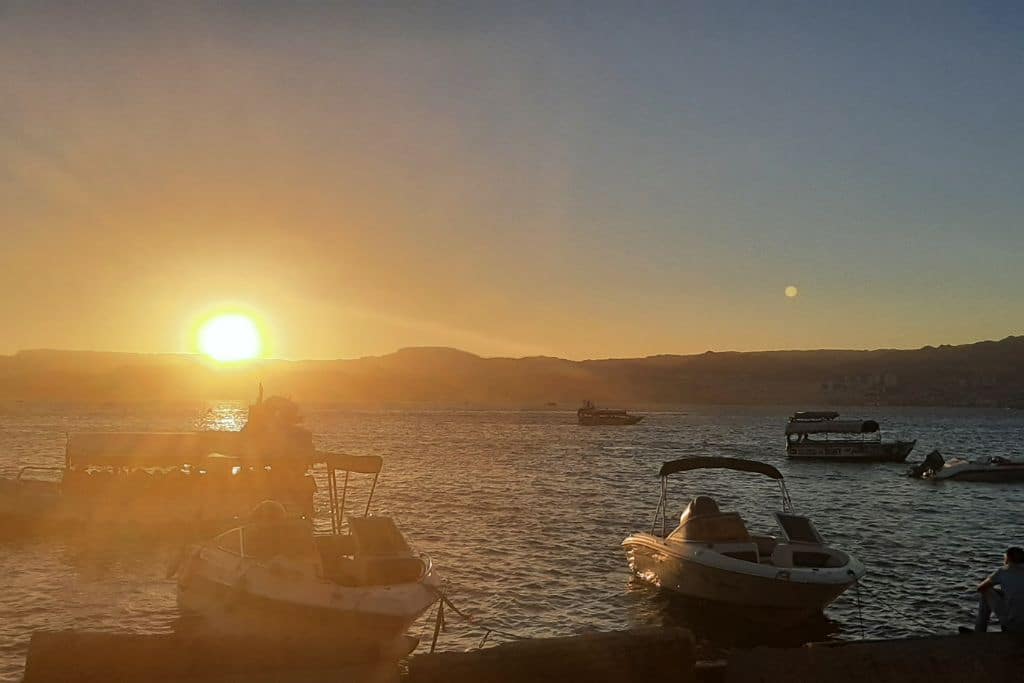Small yachts and glass-bottom boats as the sun sets in Aqaba.