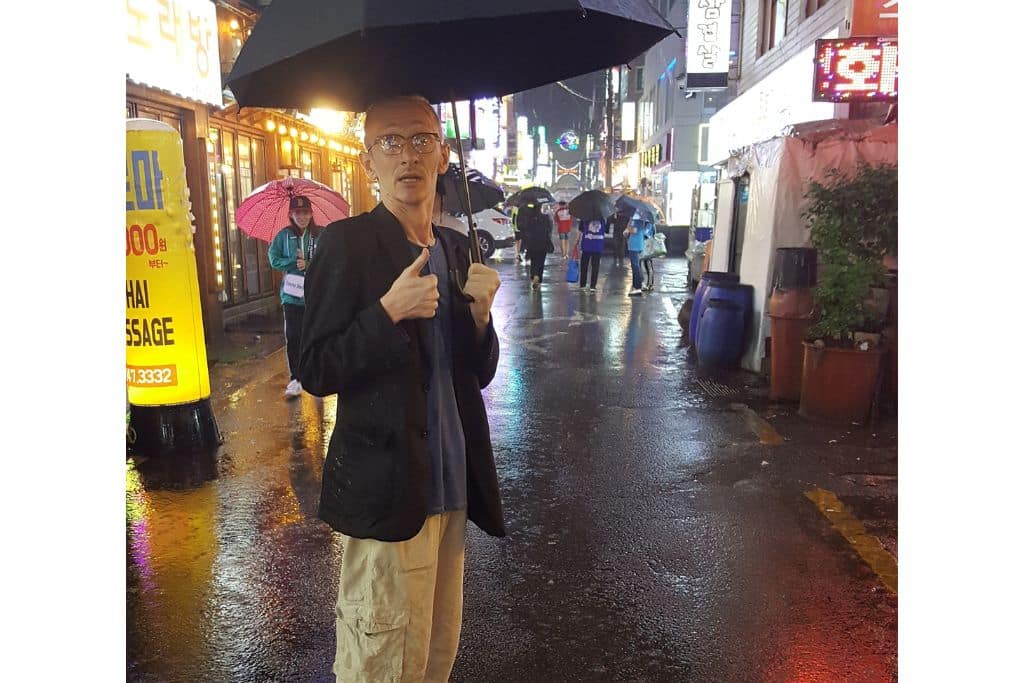 Umbrella in hand during the monsoon season in Busan, not Seoul.